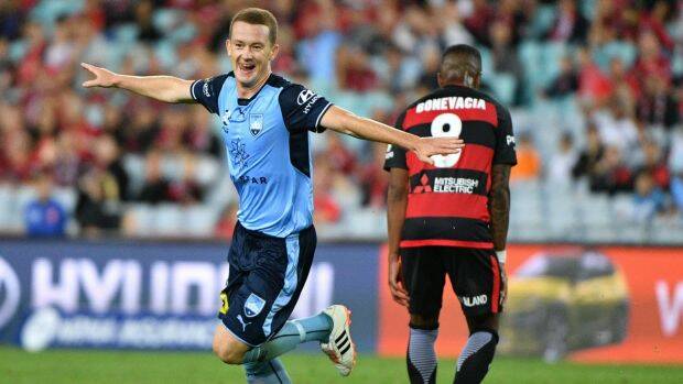 Taking off: Brandon O'Neill celebrates Sydney's fifth goal in the derby. Photo: AAP
