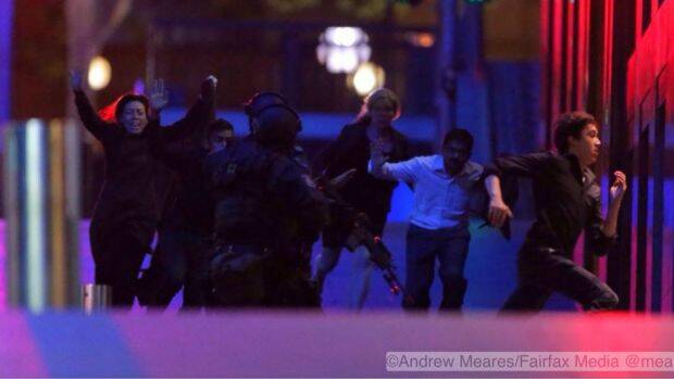 Hostages flee the Lindt cafe  Photo: Andrew Meares