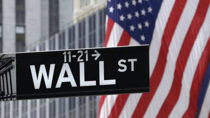 This July 6, 2015 photo shows a Wall Street sign near the New York Stock Exchange. Most major global markets rose Thursday, July 30, 2015, after the U.S. Federal Reserve left interest rates unchanged at a record low, corporate earnings mostly did better than expected and investors awaited U.S. economic growth figures. (AP Photo/Mark Lennihan)