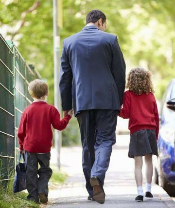 Dad taking his kids to school.  Photo:  SMH