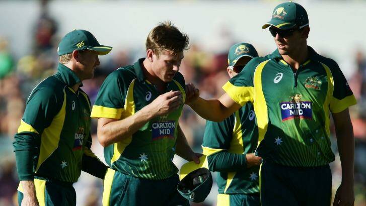 Big loss: James Faulkner is consoled by teammates as he leaves the field injured during the final match of the tri-series. Photo: Matt King