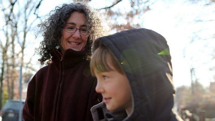 Danielle Meitiv waits with her son Rafi Meitiv, 10, for Danielle's daughter Dvora Meitiv, 6, to be dropped off at the neighborhood school bus stop in Silver Spring. Photo: The Washington Post