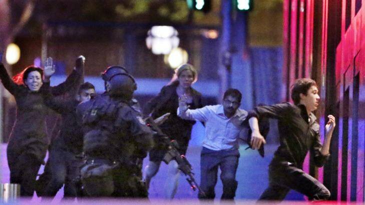 Hostages flee from the Lindt cafe in Martin Place during the early hours of December 16, 2014. Photo: Andrew Meares