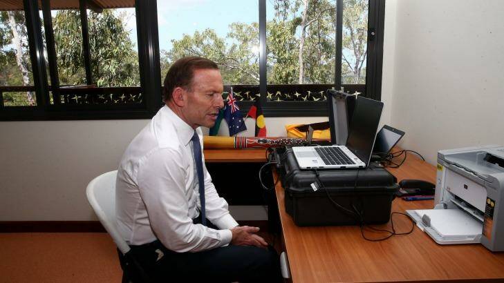 Prime Minister Tony Abbott speaks with ASIO Director-General Duncan Lewis via a secure tele-conference from Arnhem Land.  Photo: Alex Ellinghausen