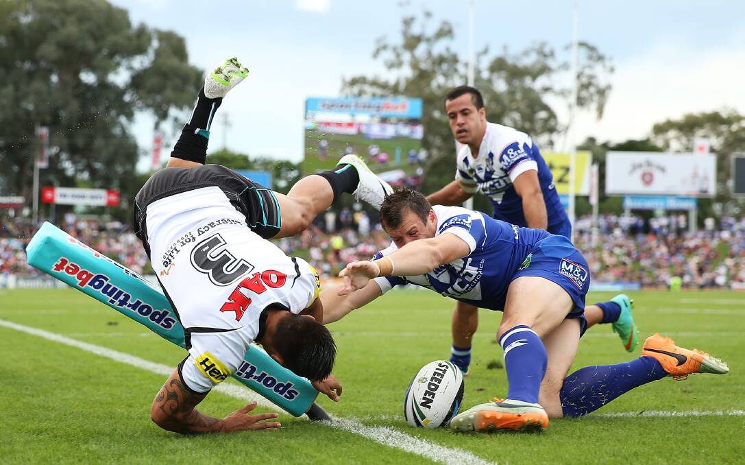 SYDNEY, AUSTRALIA - MARCH 22:  Dean Whare of the Panthers dives to score a try as he is challenged by Josh Morris of the Bulldogs during the round three NRL match between the Penrith Panthers and the Canterbury-Bankstown Bulldogs at Sportingbet Stadium on March 22, 2014 in Sydney, Australia.  (Photo by Mark Metcalfe/Getty Images) dean whare, round 3 NRL 2014. Picture: Getty Images