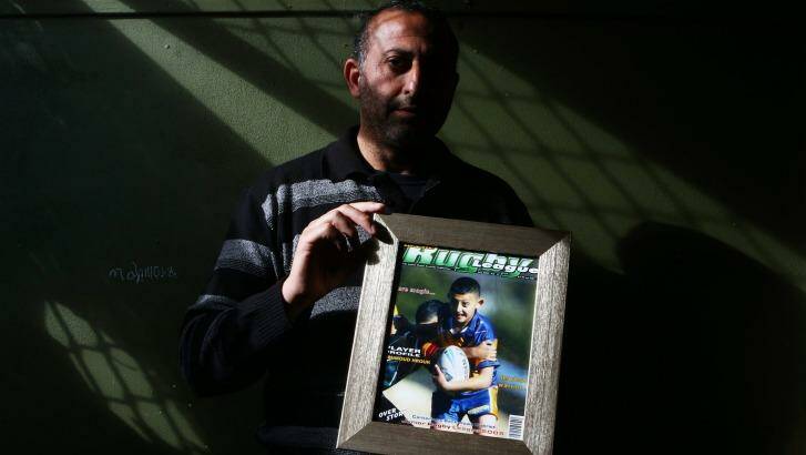 Azzam Hrouk, father of Mahmoud Hrouk, with a picture of his murdered son.   Photo: Daniel Munoz