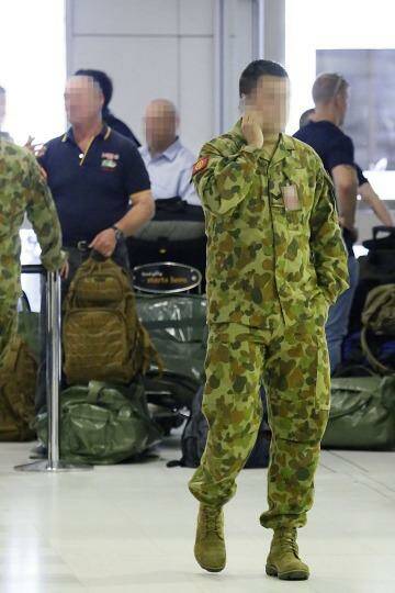 Departure: Over 80 troops checked through Sydney Airport's commercial terminal en route to Iraq. Photo: Diimex