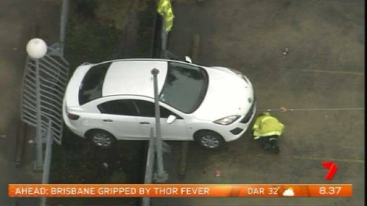 The vehicle dangles off the edge of the Westmead Hospital car park. Photo: Channel Seven