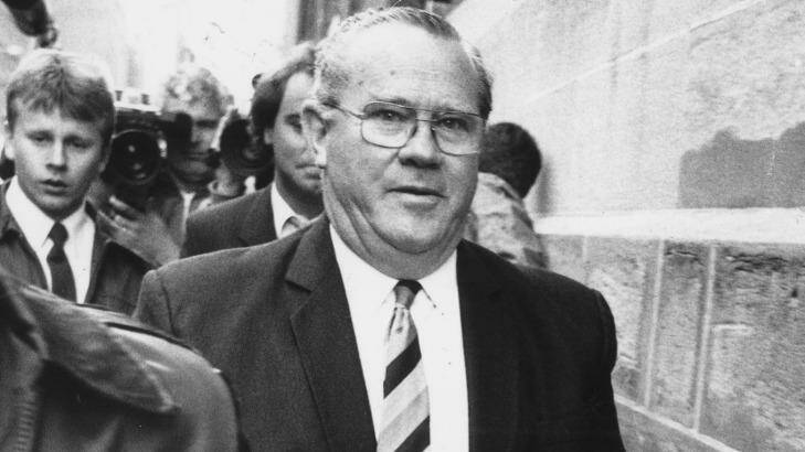 Rex "Buckets" Jackson, the former prisons minister, is led into court in handcuffs in 1987. Photo: Fairfax Archive