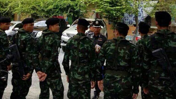 Thai police at the apartment block where the man was arrested.  Photo: Thai Police