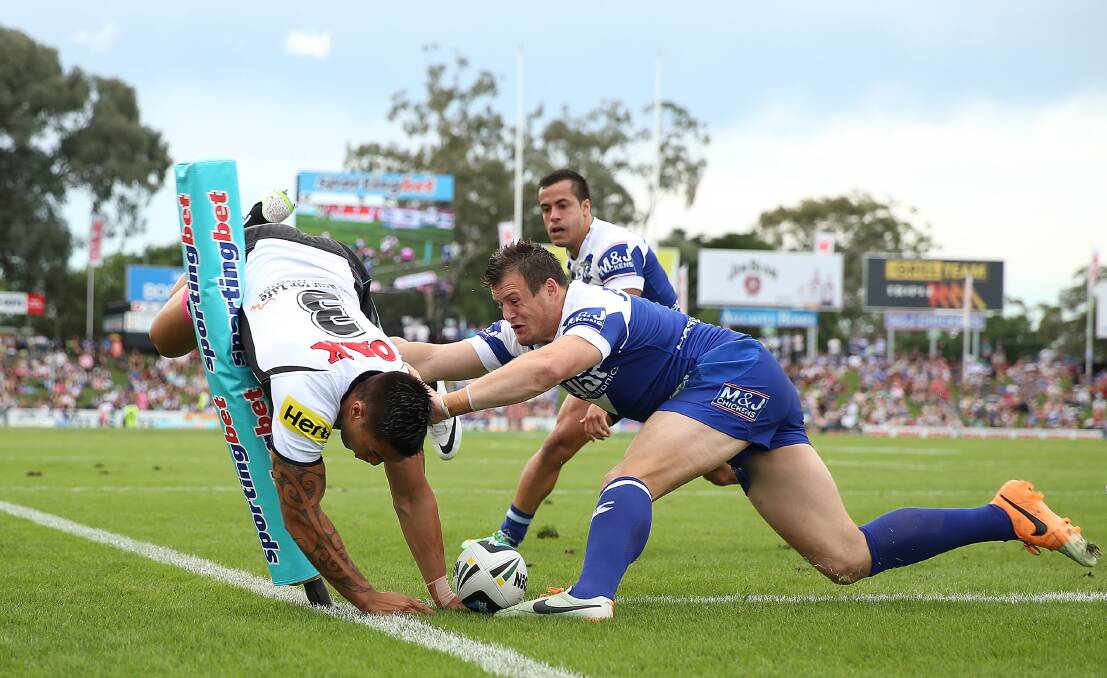 SYDNEY, AUSTRALIA - MARCH 22:  Dean Whare of the Panthers dives to score a try as he is challenged by Josh Morris of the Bulldogs during the round three NRL match between the Penrith Panthers and the Canterbury-Bankstown Bulldogs at Sportingbet Stadium on March 22, 2014 in Sydney, Australia.  (Photo by Mark Metcalfe/Getty Images) dean whare, round 3 NRL 2014. Picture: Getty Images
