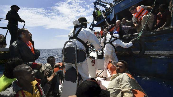 Refugees on a wooden boat carrying 565 people are rescued off the Libyan coast by Migrant Offshore Aid Station crew. Photo: Kate Geraghty