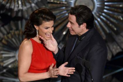Idina Menzel, left, and John Travolta present the award for best original song at the Oscars at the Dolby Theatre in Los Angeles. Photo: John Shearer/Invision/AP