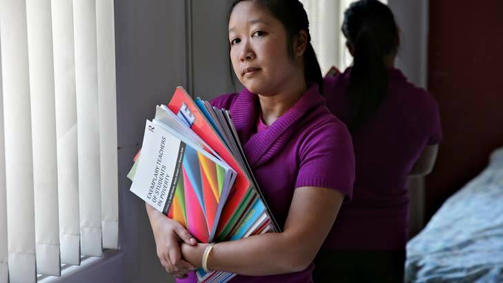 Out of pocket: Casual primary school teacher Jane Le with her resource books. Photo: Brendan Esposito