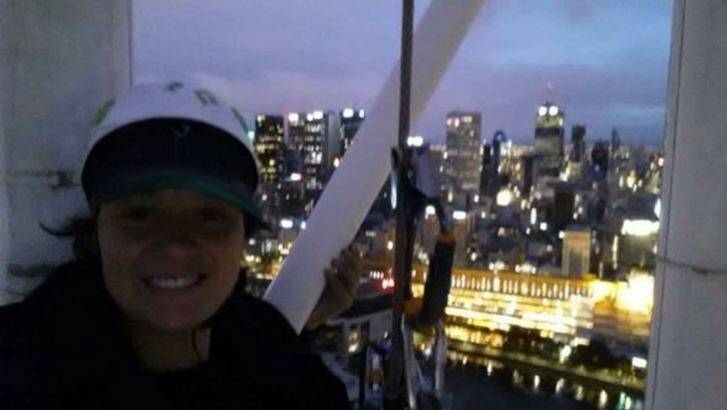 Protester Katherine Woskett on the Arts Centre spire.
