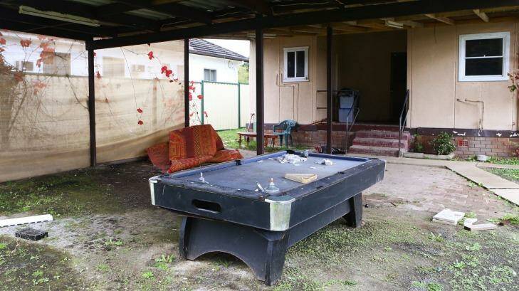 At the back of the house is a navy pool table covered in dirt and strewn with tea bags. Photo: Daniel Munoz