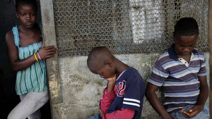 Lost education: Orphans Promise,16, Emmanuel jnr, 11, and Benson Cooper, 15, at their home in Monrovia, Liberia, after losing their parents to Ebola.