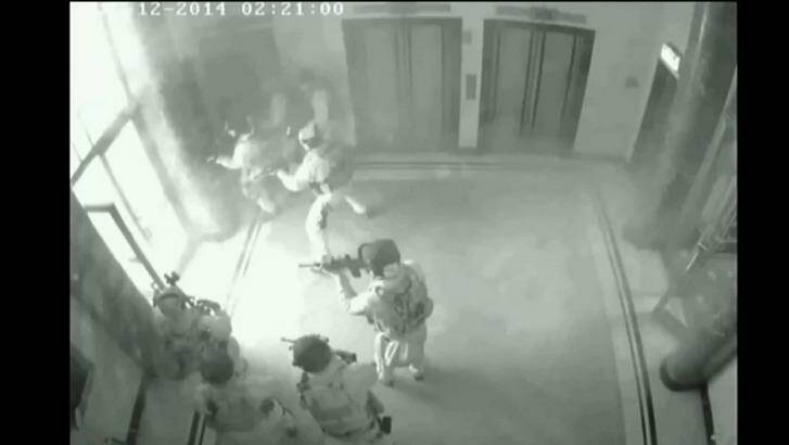 CCTV footage shows police storming the cafe at 2:21am.