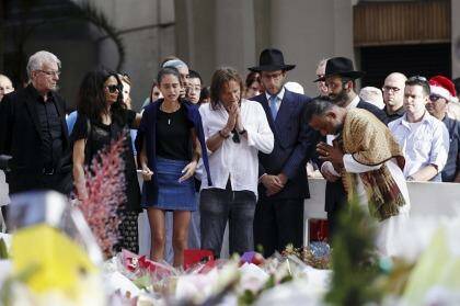 Sydney siege victim Tori Johnson's family meet with religious leaders at the Martin Place shrine to the hostages. Photo: James Brickwood. 