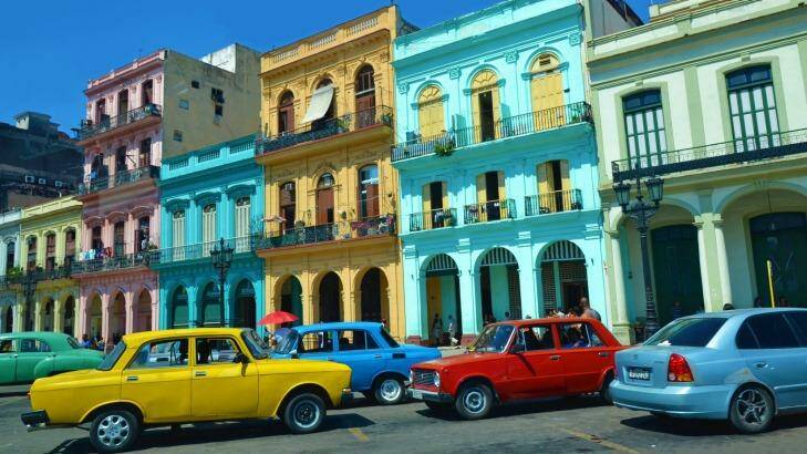 Colourful cars parked in front of historic buildings in Havana, Cuba.  Photo: Maisna