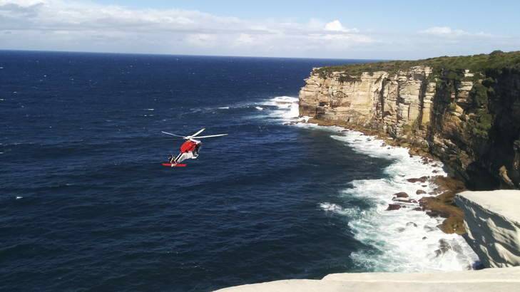 A rescue helicopter hovers off Little Marley Beach after a bushwalker fell to his death. Photo: Jenna Mollross