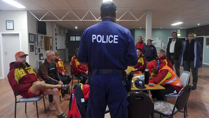 Police and surf life saving personnel, hold a briefing on Friday morning in the Tathra club rooms. Photo: Graham Tidy