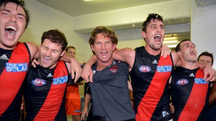 In happier times: James Hird celebrates with his players after a narrow loss. Photo: Sebastian Costanzo