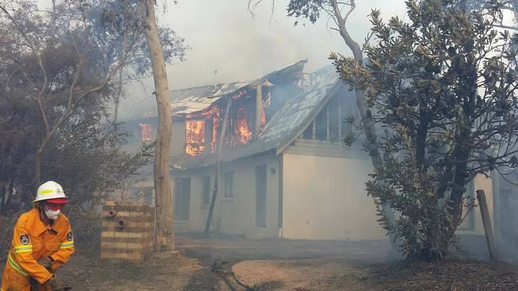Firefighters try to save a house at Katoomba. Photo: Nine News/Top Notch Video