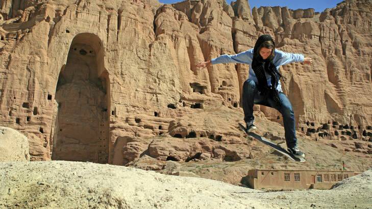 Kabul kickflip: Skateistan volunteer Erika Kinast at the site of the destroyed Buddhas of Bamiyan. Photo: Skateistan