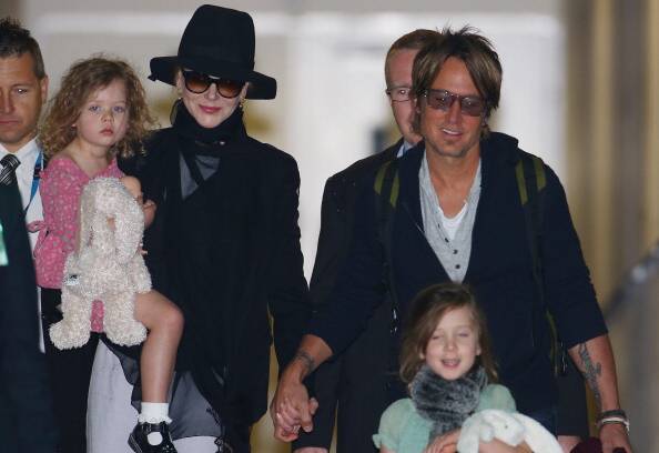 Keith Urban keeps a close eye on daughter Sunday Rose as wife Nicole Kidman and daughter Faith look on.