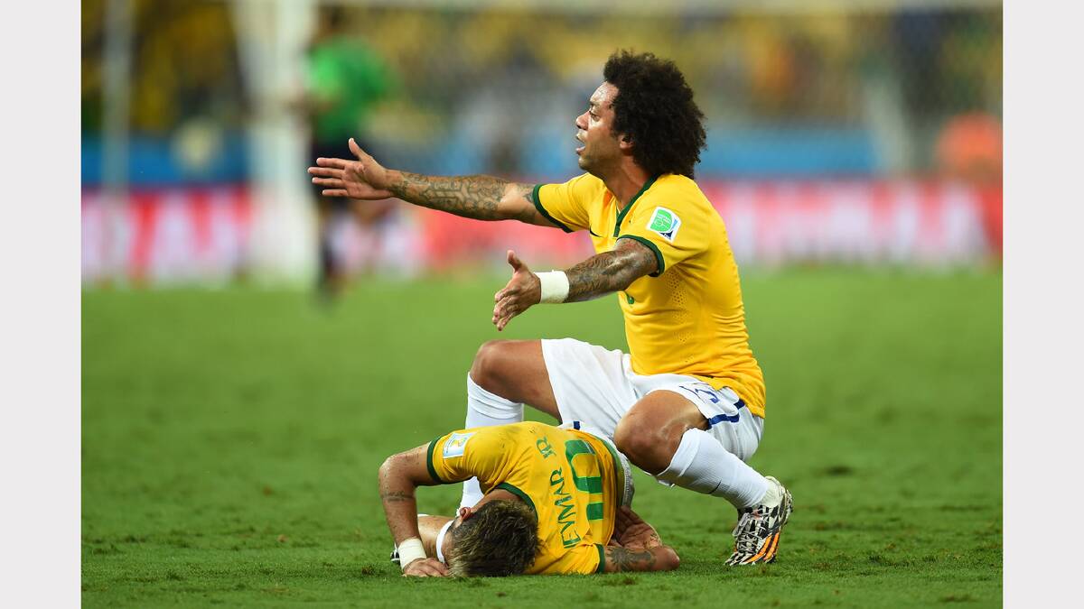 Brazil's Marcelo calls to the bench for help as teammate Neymar lies writhing on the ground in agony. Photo: Getty Images