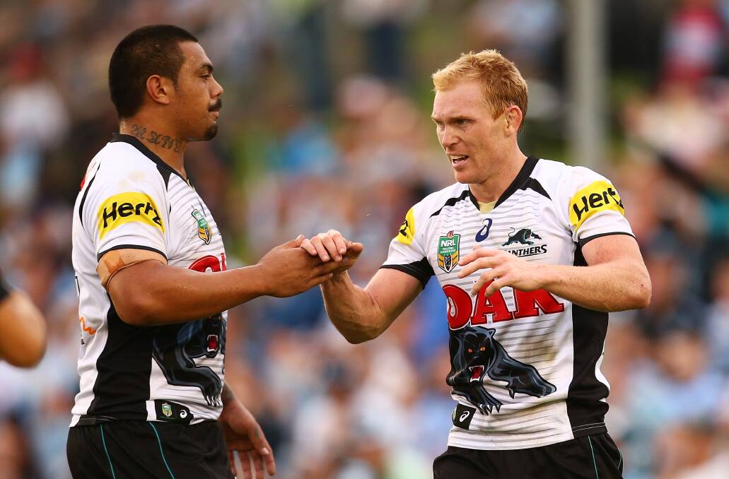 SYDNEY, AUSTRALIA - APRIL 26: Peter Wallace of the Panthers is congratulated after scoring during the round 8 NRL match between the Cronulla-Sutherland Sharks and the Penrith Panthers at Remondis Stadium on April 26, 2014 in Sydney, Australia. (Photo by Mark Nolan/Getty Images)