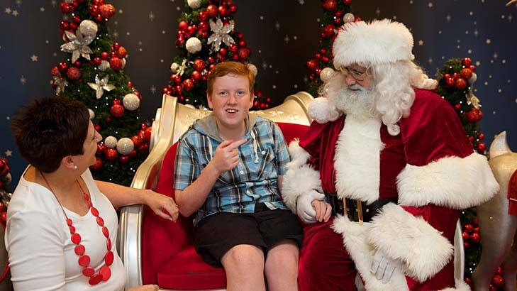 Protective environment: Nathan Beavan, 14, enjoys a visit to Santa at Rouse Hill Town Centre. Photo: Wolter Peeters