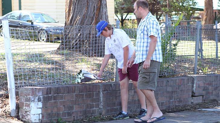 People drop off flowers at the scene of a fatal car accident at Carlingford Public School. Photo: Brendan Esposito